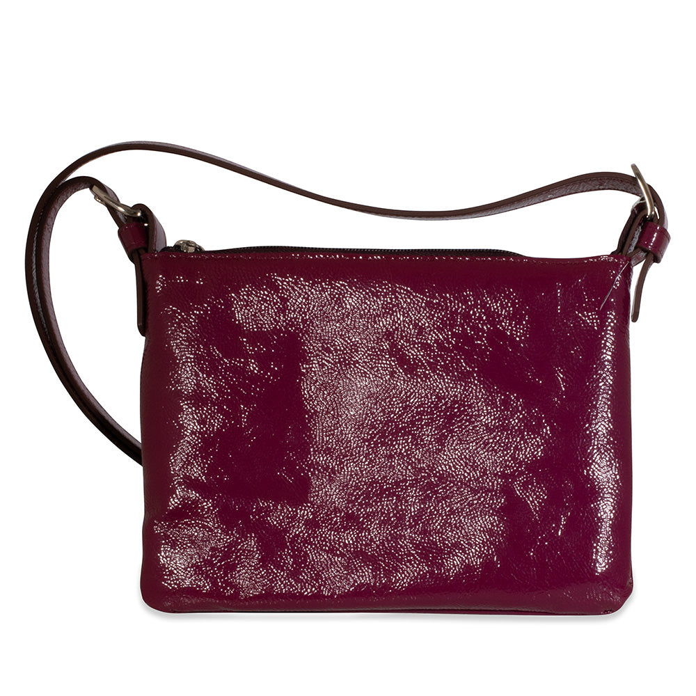 Cherry leather handbag with a textured surface on a white background