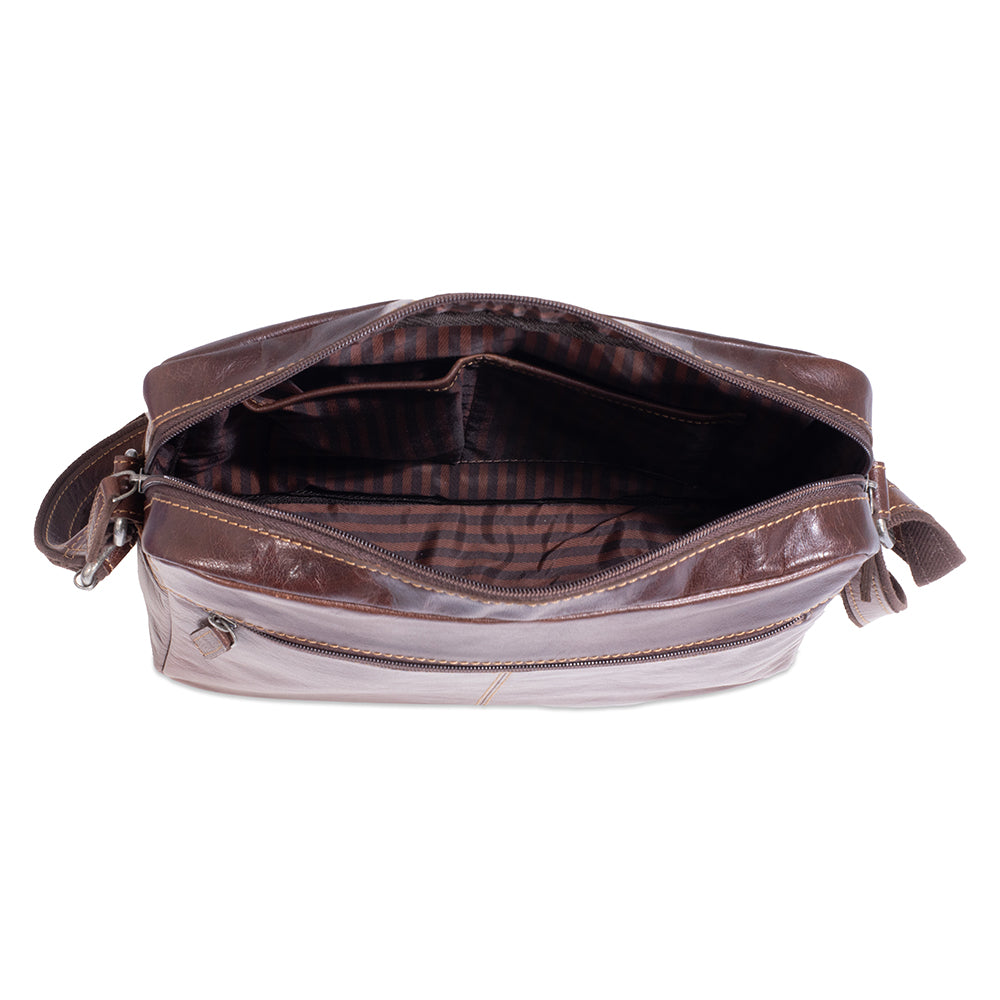 Brown leather bag with plaid lining on a white background