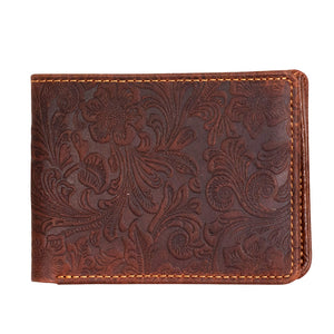 Brown leather wallet with floral embossing on a white background