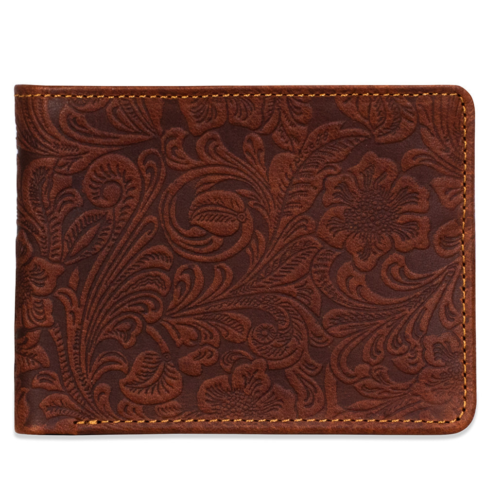 Brown leather wallet with floral embossing on a white background