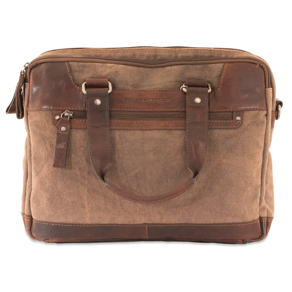 Brown leather and canvas bag with a handle on a white background