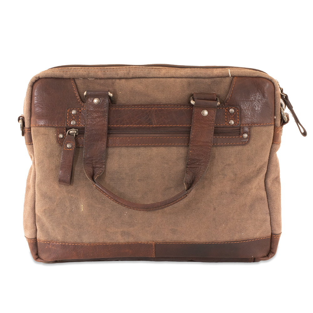 Brown leather and canvas bag with a handle on a white background
