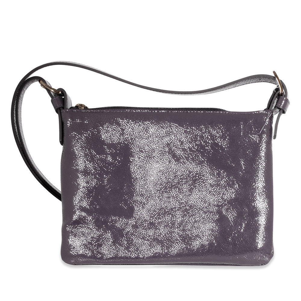 Violet leather handbag with a textured surface on a white background