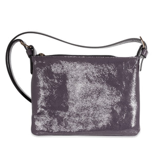 Violet leather handbag with a textured surface on a white background